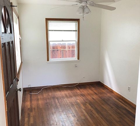 Family room with new ceiling fan and wood floors
