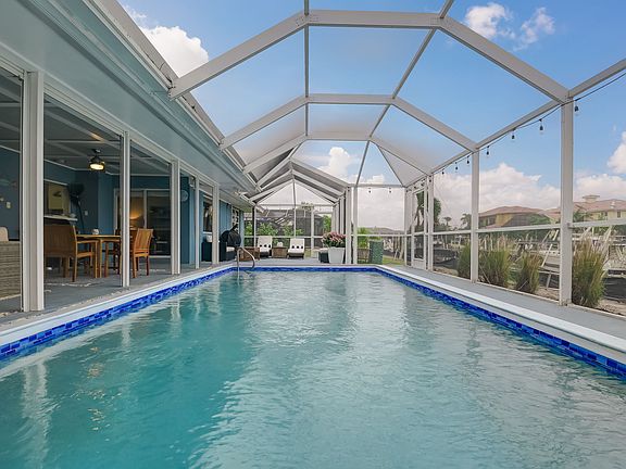 Heated pool overlooks the water, and the expansive lanai has multiple areas to relax and lounge.