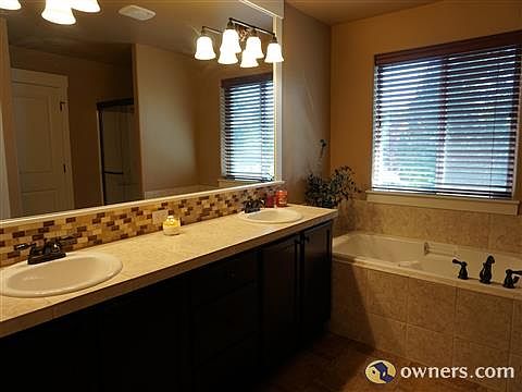 Master bath with dual sinks and separate soaking tub