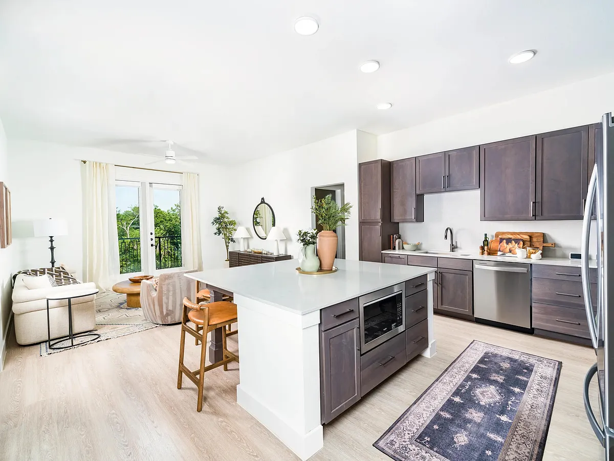 Sleek kitchens at Modera Trailhead feature spacious islands, designer finishes, and open layouts that flow seamlessly into bright living areas. - Modera Trailhead