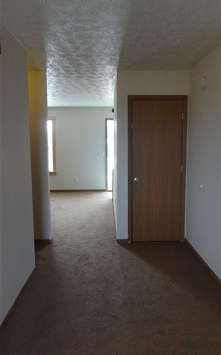 Hallway from foyer past the living room, past 1/2 bath into