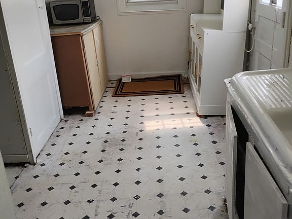 Kitchenette with new cabinet, cupboard, and repainted.