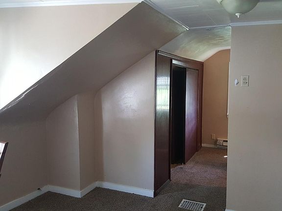 Dining/kitchen area down hall toward bathroom.