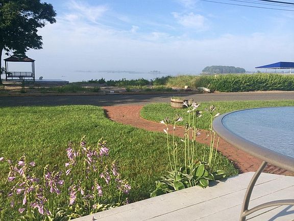Your private beach and beach deck is just across from an outside deck off the house and a spacious green lawn