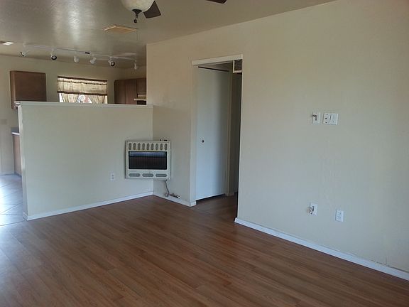 Living Room with view of hallway, kitchen, and heater