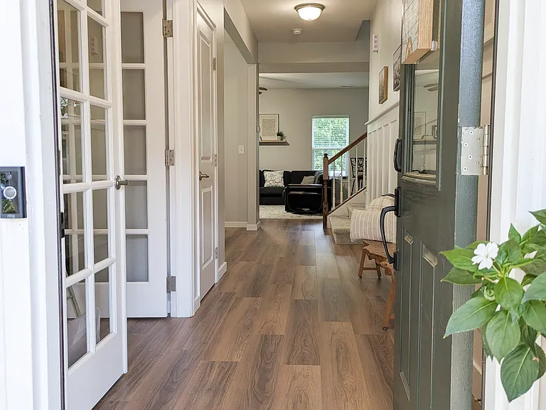 Entry way. Office/Study to left with double french doors. (reflects new laminate flooring)