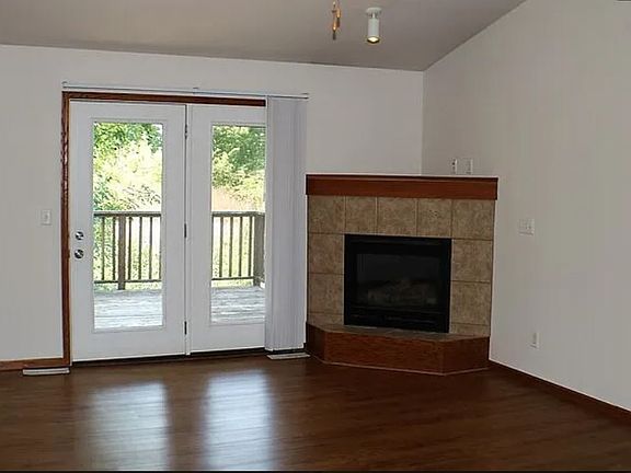 Living room w/ gas fireplace and doors to deck