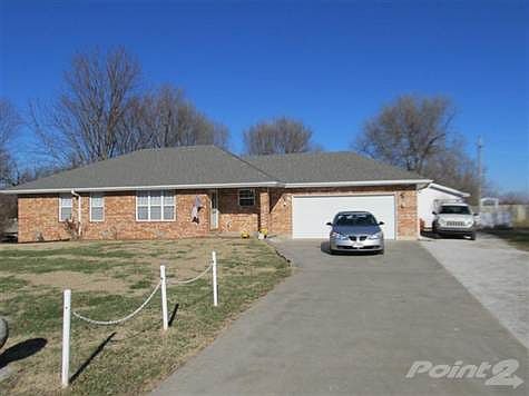 Driveway entry is a level concrete approach without cracks or defect and has a side gravel entry to the outbuilding behind the house.