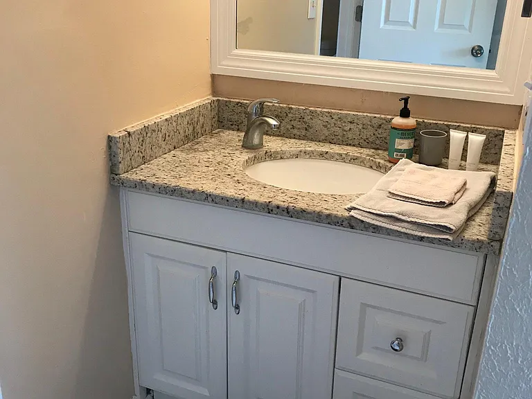 North bedroom private vanity and sink in bedroom.