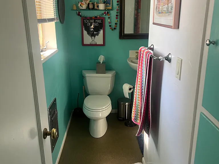 Bathroom with a stall shower with beautiful yellow tile.
