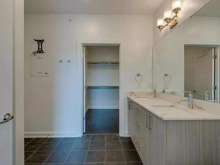 Huge Master Bath with Tile Floors, Double Vanity, Quartz Countertops, Chrome Fixtures and Contemporary Lighting.