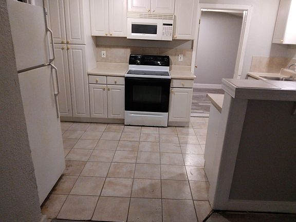 Kitchen with new tiles, cabinet and appliances