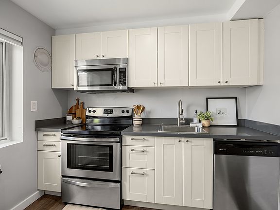 Fully renovated contemporary kitchen equipped with brand-new stainless steel appliances and sleek cabinetry.