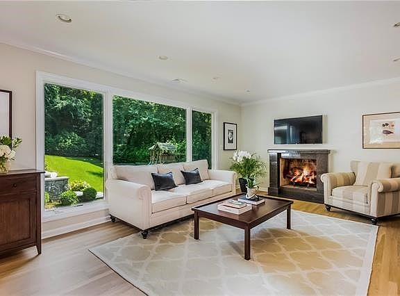 Spacious living room with large windows and fireplace