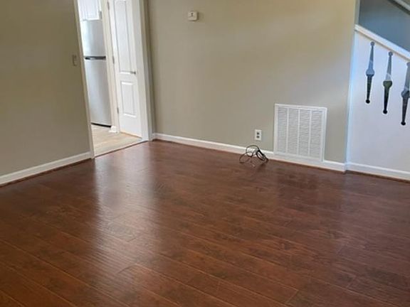 den with view of staircase and door to the kitchen