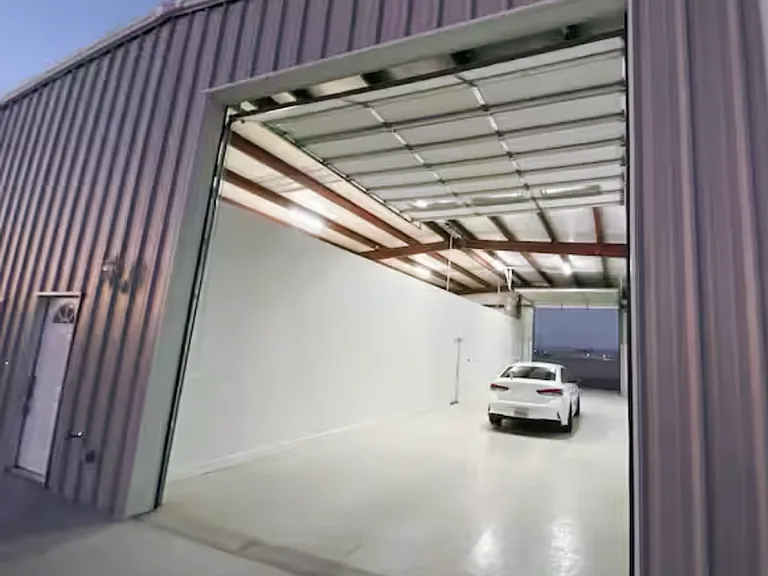 Oversized attached shop/garage with high-clearance access _ great for secure parking, storage, tools, or river toys.