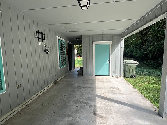 Car port looking toward laundry room door on right and side entry way on left.