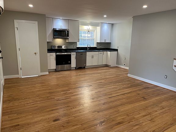 Brand new stainless steel appliances: dishwasher, range, and microwave/hood.