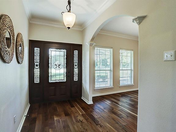 You will immediately notice the engineered hardwood flooring that flows throughout the entry and formal dining to the left.