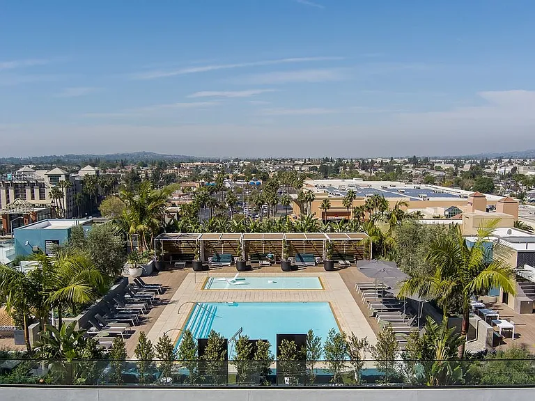 Building A rooftop pool with lounge seating and cabanas