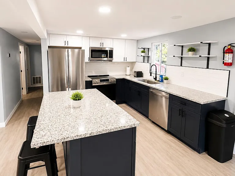 Updated kitchen with large island, stainless appliances, and ample cabinet storage plus generous counter space.