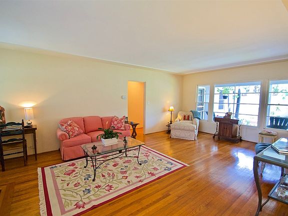 Large, light and open living room with gorgeous original hardwood floors.