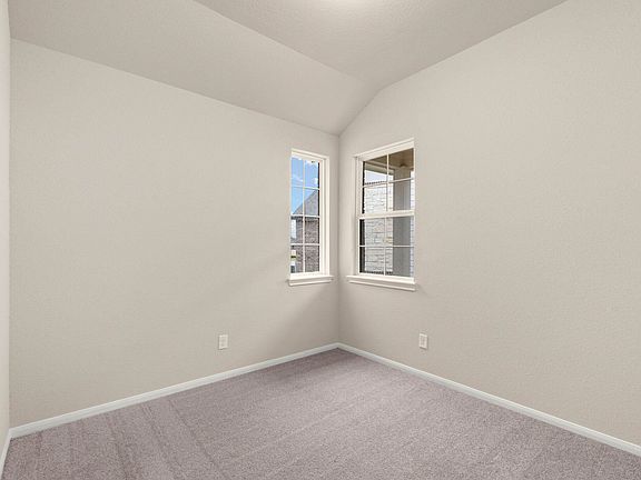 The third bedroom features plush carpet, neutral paint and two windows allowing plenty of light in.