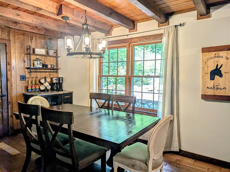 Dining Room off Kitchen with Coffee Bar. Door shown connects the main house to the game room through the attached foyer.