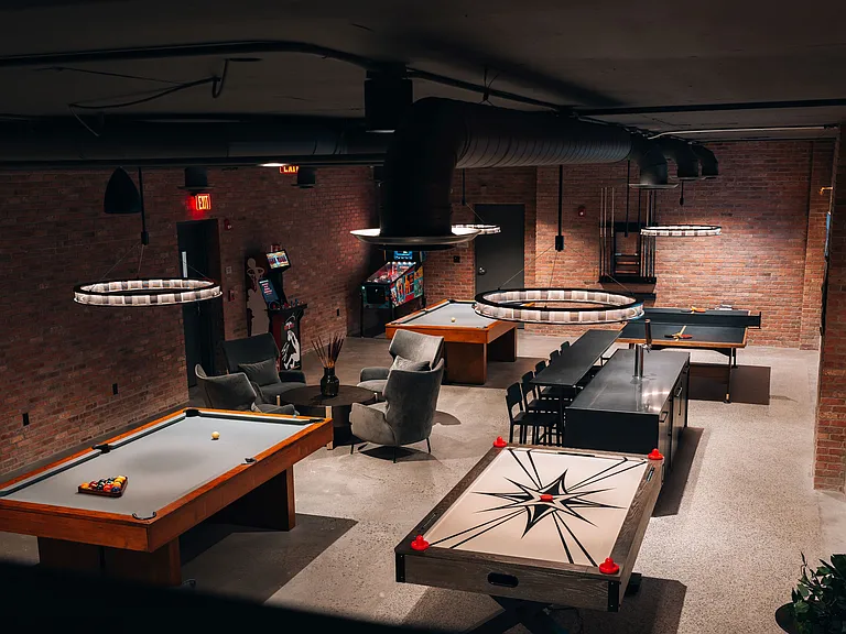 Community game room featuring billiards, ping pong, air hockey, pinball, a bar area, and virtual golf simulator