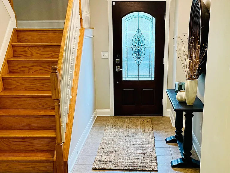 Grand entryway with multiple levels of spacious living and storage