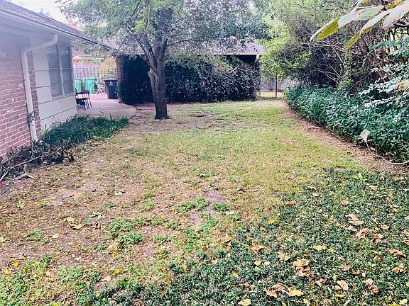 In the backyard against the east fence looking west to the two car detached garage.