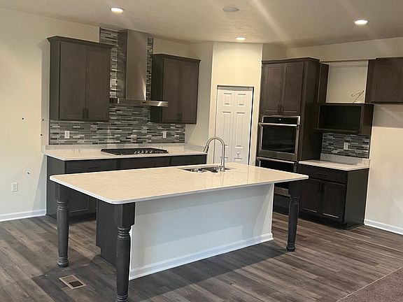 Chef s Kitchen with Stainless gas cooktop, double wall ovens