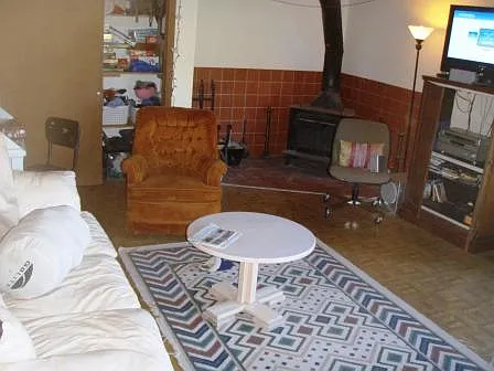 Second sizeable living room with wood stove and storage/closet space.