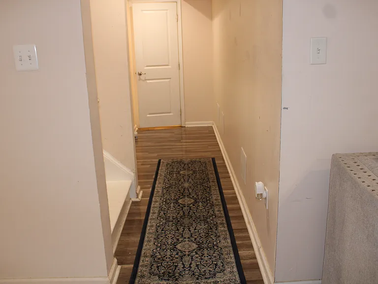 View of bath entrance and stirs to main level kitchen