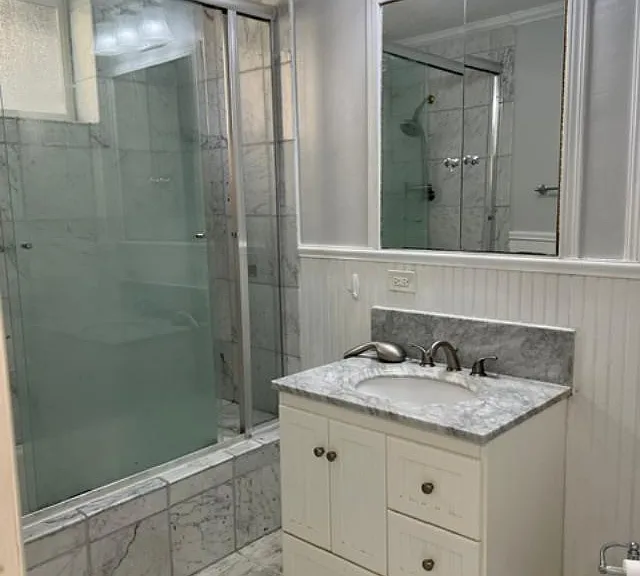 Bathroom picture 1. Two large, mirrored cupboards in bathroom. One is shown in picture.