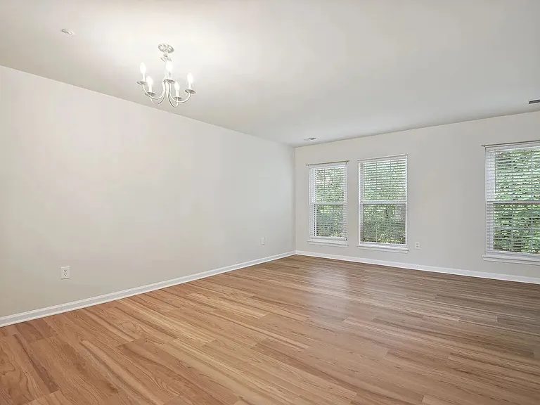 An overview of the living and dining area showing the ample windows on the north wall of the lower level.