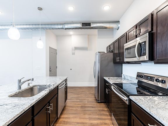 Spacious kitchen with solid wood cabinets, granite counters and stainless appliances.