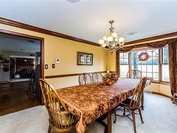The 15x12 dining room offers a beautiful view of the back yard through its large bay window! The crown moulding and chair rail o
