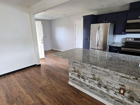 LR/kitchen looking to dining nook and door to back patio and backyard.