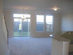 Open view of living room and fenced back patio