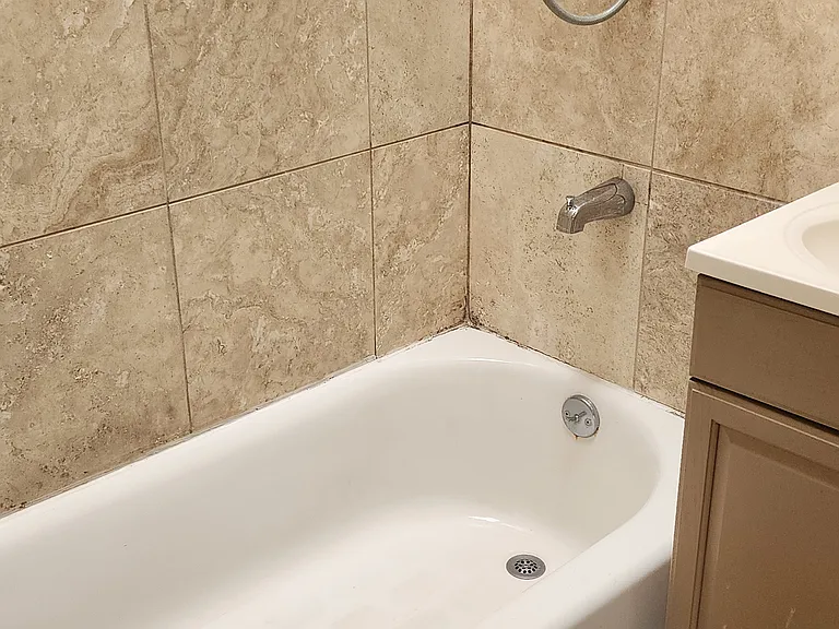full bathroom with delightful skylight that opens for fresh air. Tile flooring.