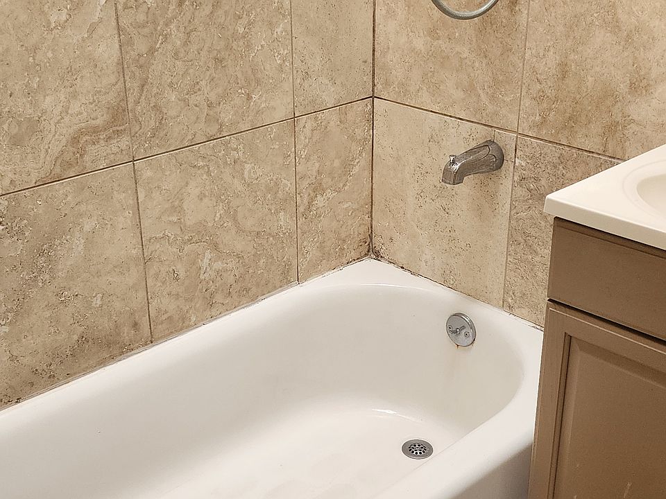 full bathroom with delightful skylight that opens for fresh air. Tile flooring.