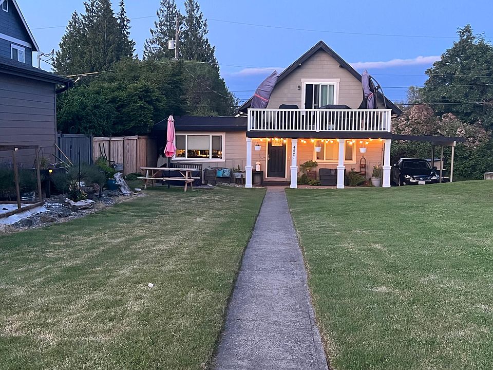Front of home featuring new pillars, picnic area, raised garden beds. Beautiful views of the sound from front sidewalk.