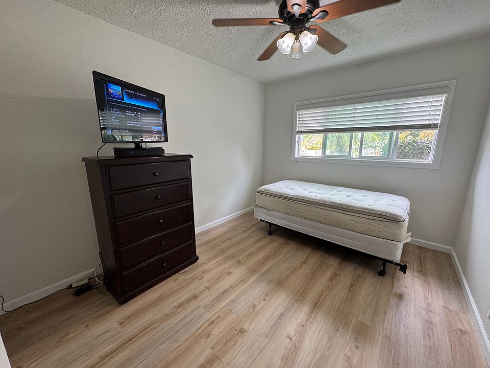 Bedroom with single (twin) bed, dresser & 32" TV