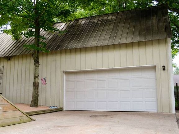 Wow!  This stunning garage and pole barn combo offers lots of room for your toys and hobbies.  Keep reading for more photos below.