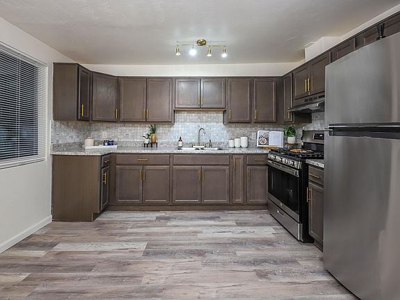New trendy gold hardware. White & Gold porcelain backsplash.