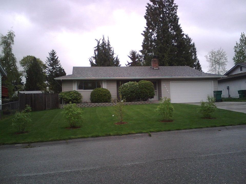 From the street, gorgeous lawn and stonework flowerbox