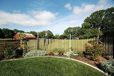 Beautifully landscaped backyard, waterfall, hot tub, covered patio and privacy