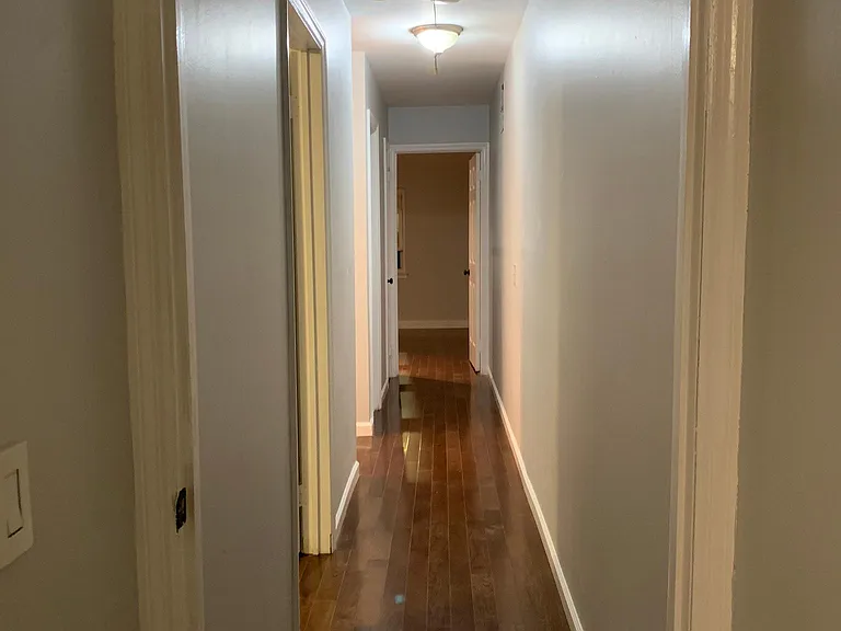 upstairs bedroom hallway with attic storage
