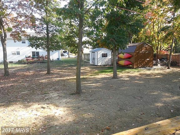 Fully fenced back yard with storage shed